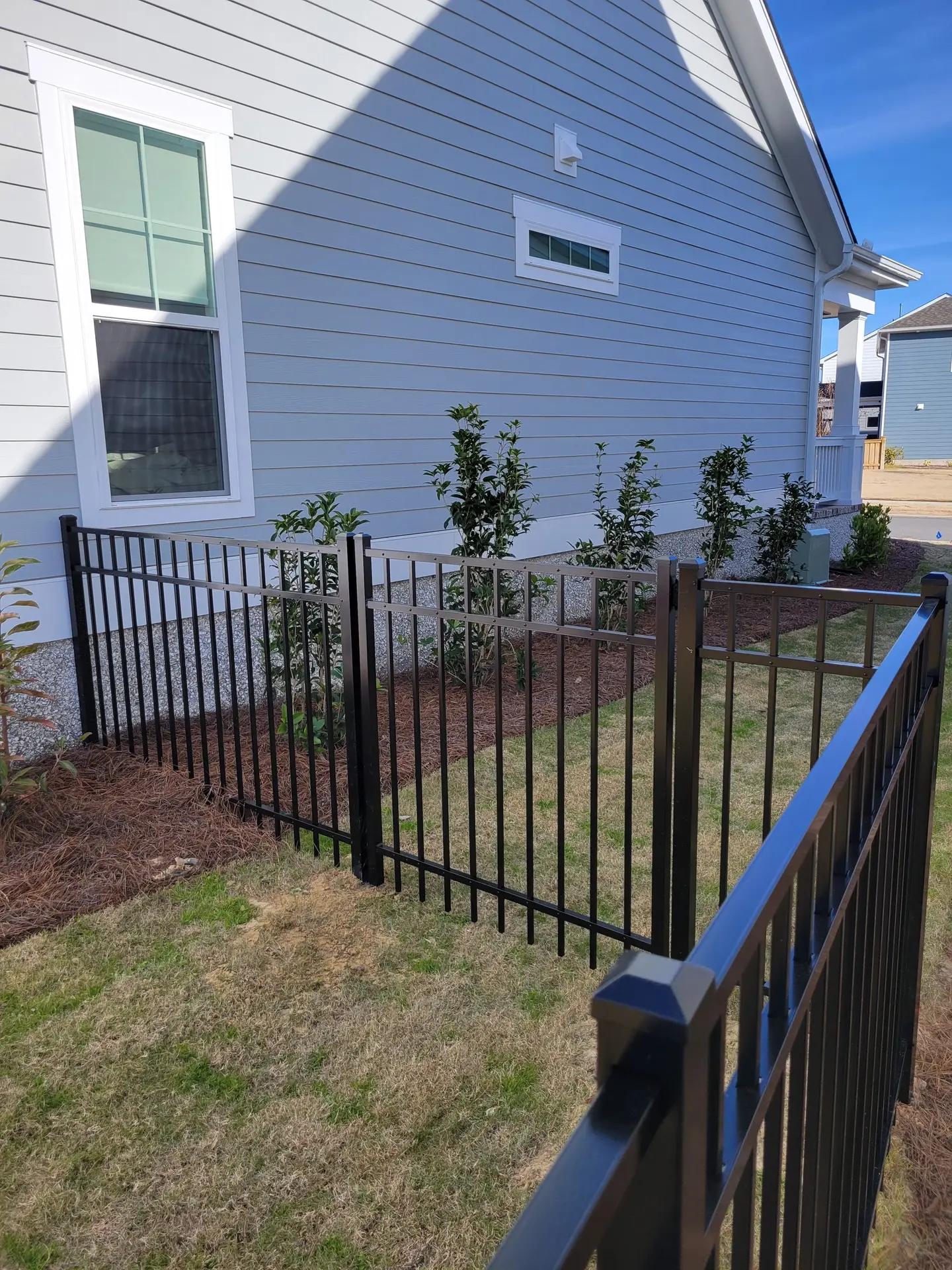 Decorative aluminum fence with curved gate showcasing security and elegance