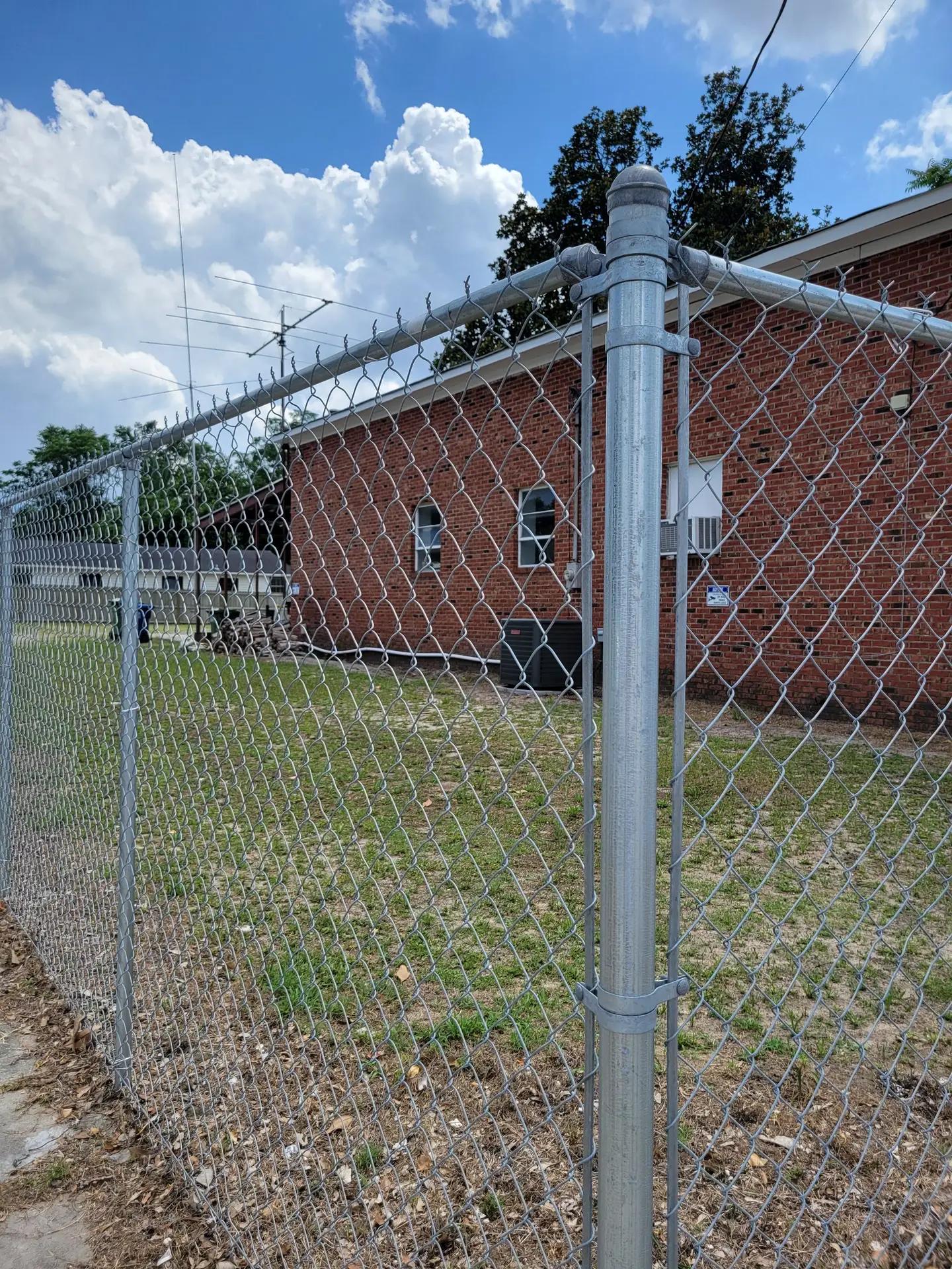Chain-link fence with barbed wire providing reliable perimeter security for industrial properties