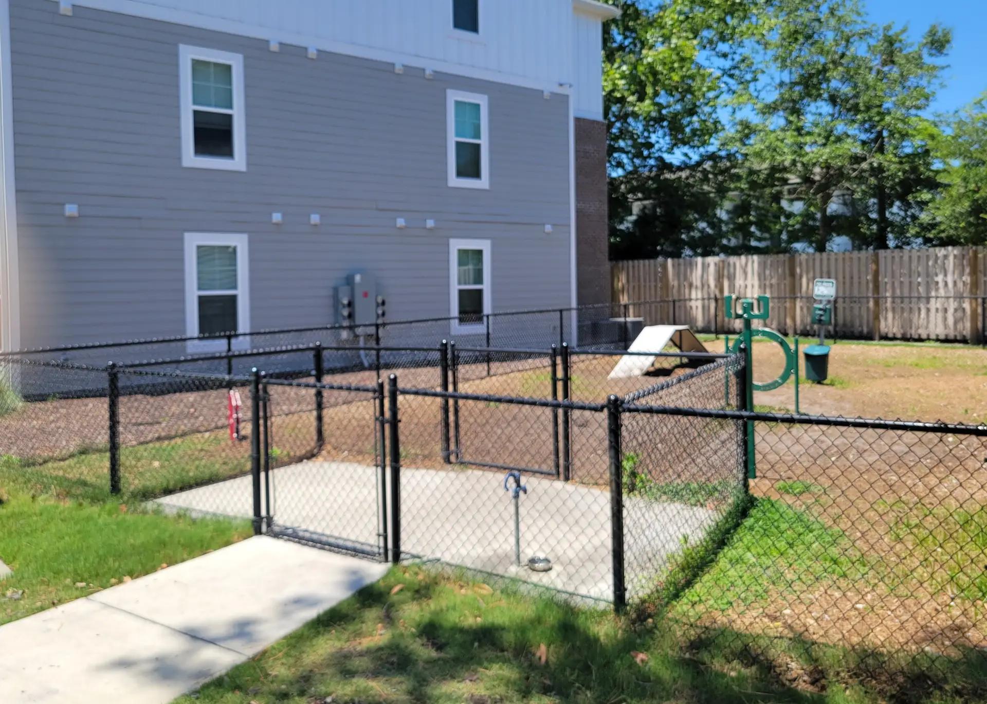 Heavy-duty commercial chain-link fence with privacy slats for industrial security