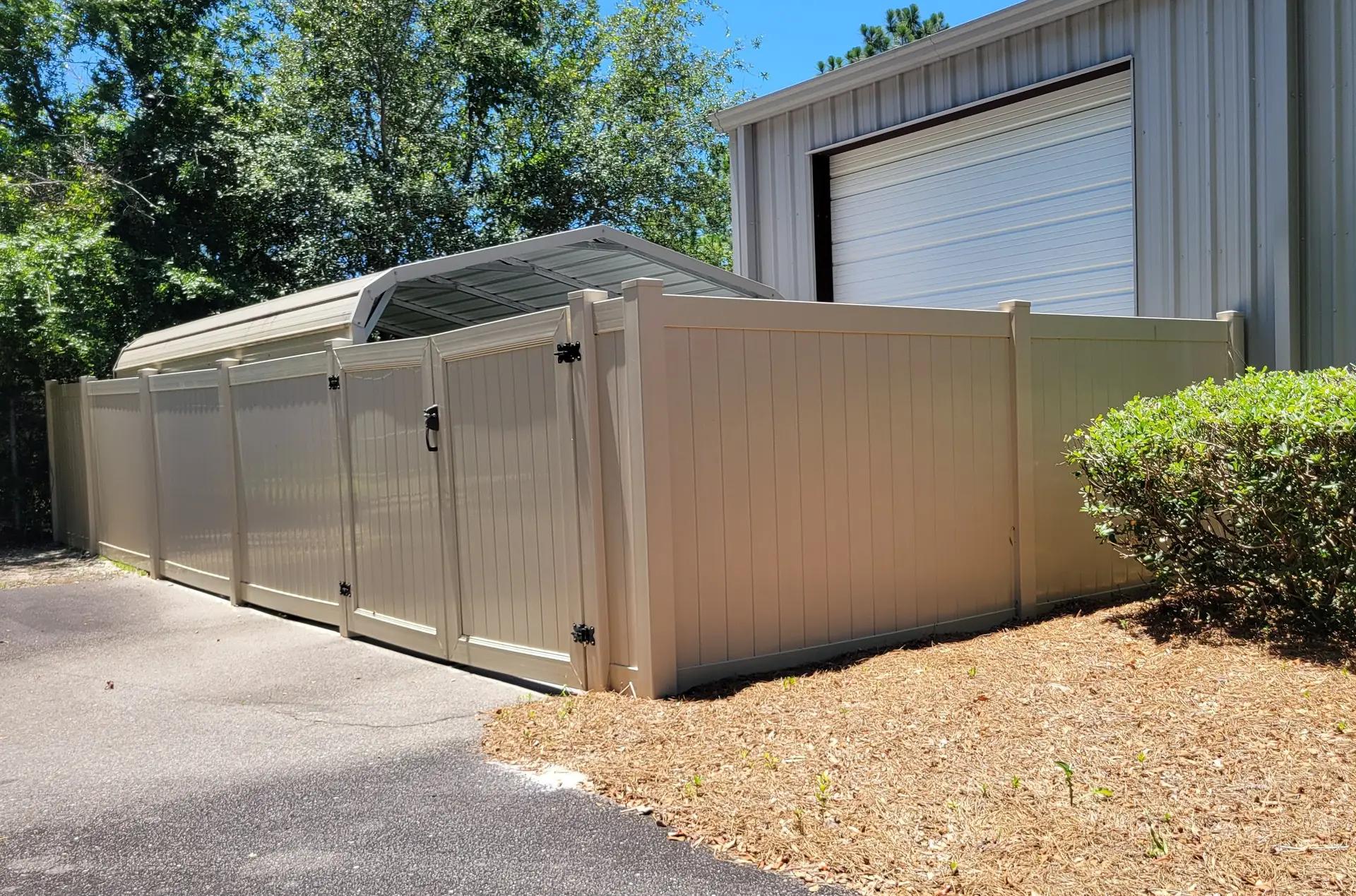 Beige vinyl privacy fence with modern design providing complete backyard privacy