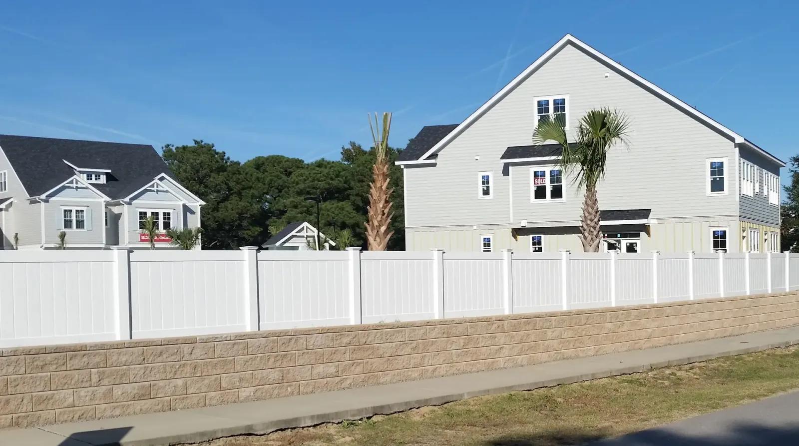 White vinyl fence on a corner property showcasing beautiful and modern design, ideal for coastal living environments like Wil