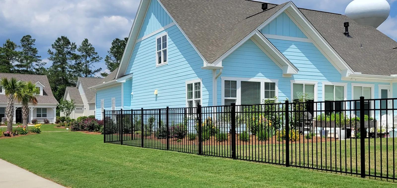 Aluminum fence elegantly bounding a serene residential landscape showcasing professional craftsmanship and quality fence inst