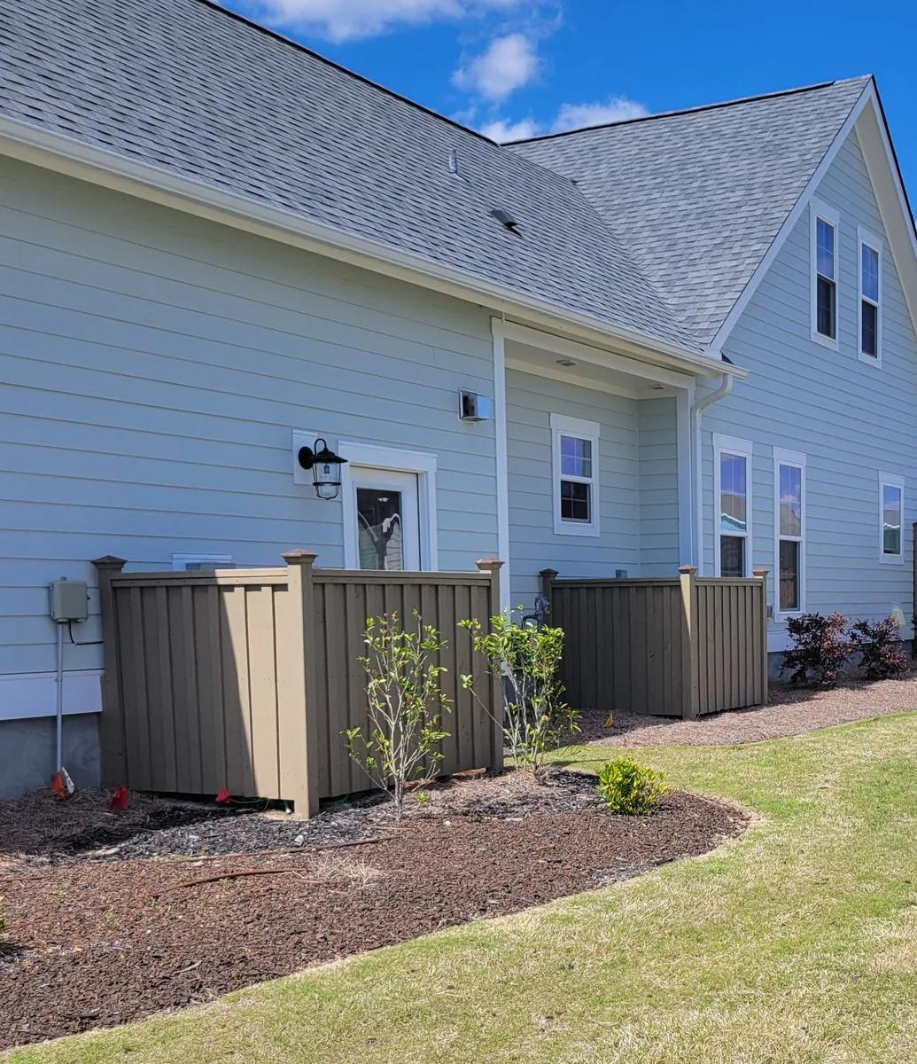 Custom wooden HVAC enclosure built with pressure-treated wood, showcasing professional craftsmanship for coastal North Caroli