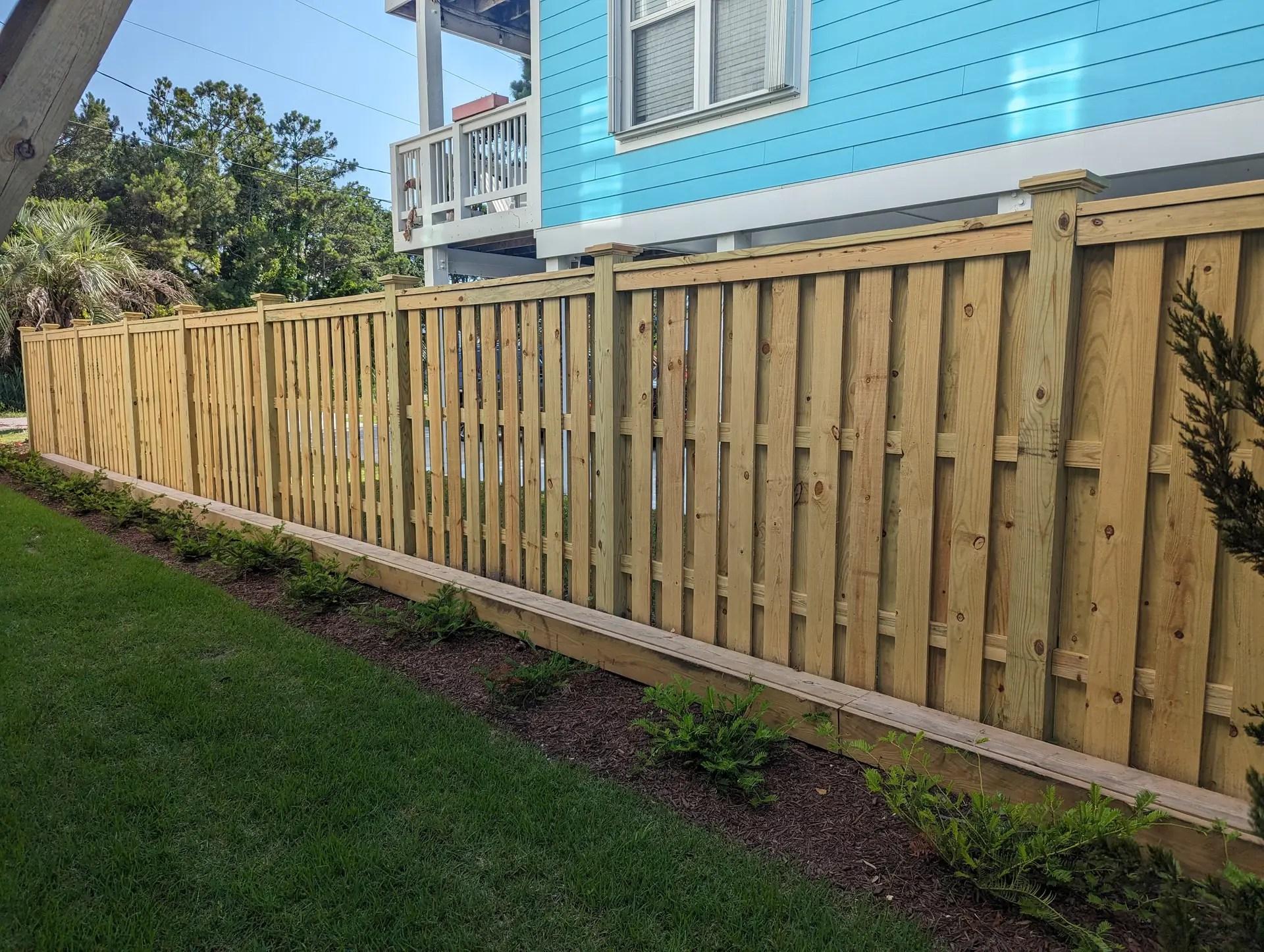 Wooden fence and retaining wall showcasing classic craftsmanship showcasing professional craftsmanship and quality fence inst
